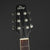Guitar headstock with 'The Heritage' branding on a dark background